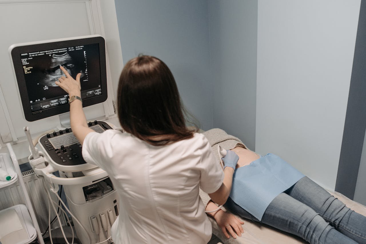 services-01 Female doctor conducting an ultrasound screening on a patient in a medical office.