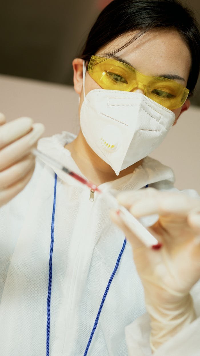 services-03 Close-up of a researcher in protective gear conducting a laboratory experiment with precise tools.